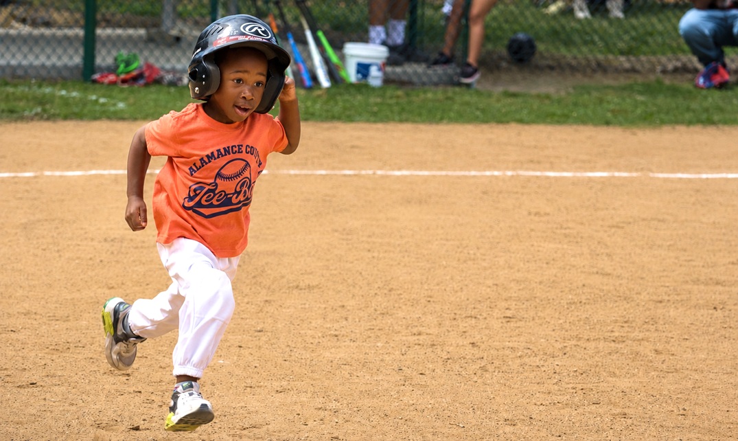 Child running on baseball field